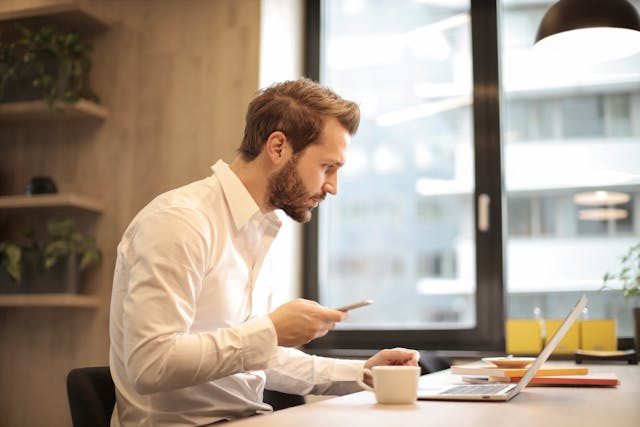 Person in white shirt working at computer