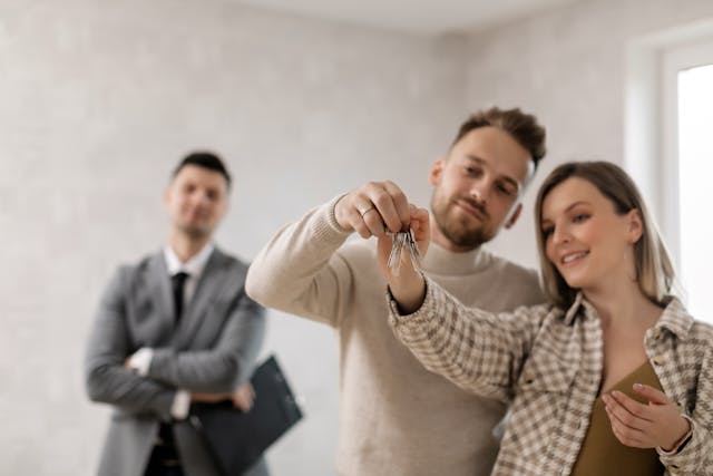 Tenants holding up new key to apartment 