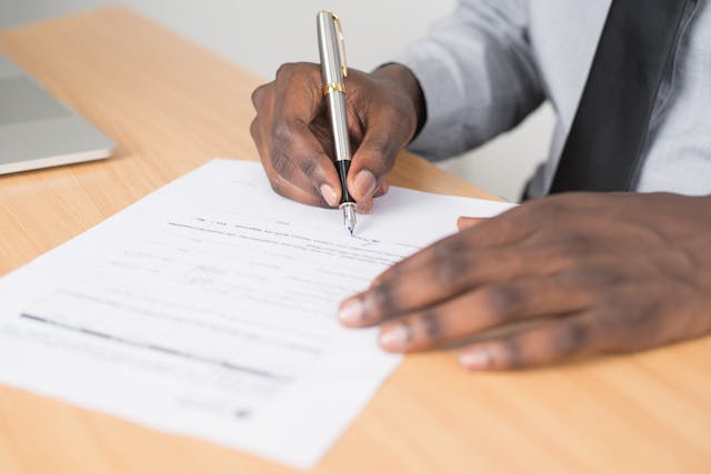 person signing a document